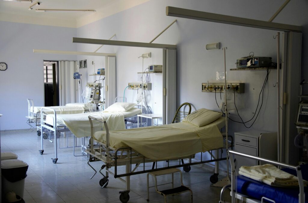 pexels-photo-236380-236380 Spacious hospital room with several empty beds and medical equipment, emphasizing healthcare and hygiene.